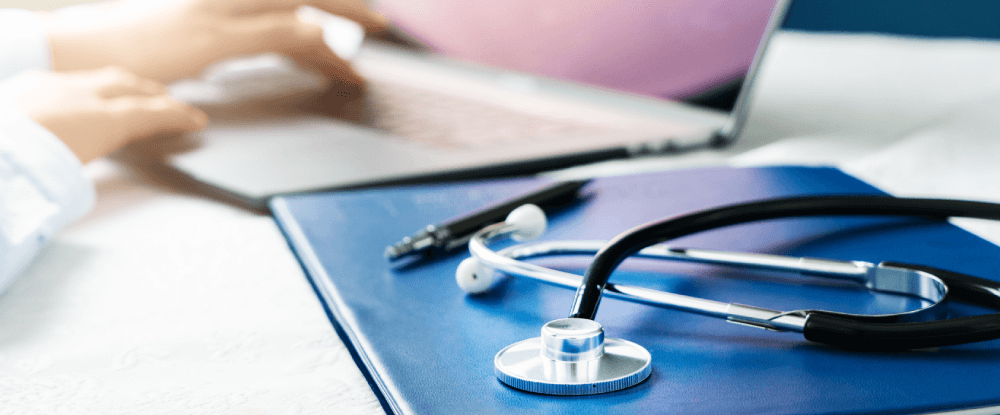 Doctor typing on a laptop